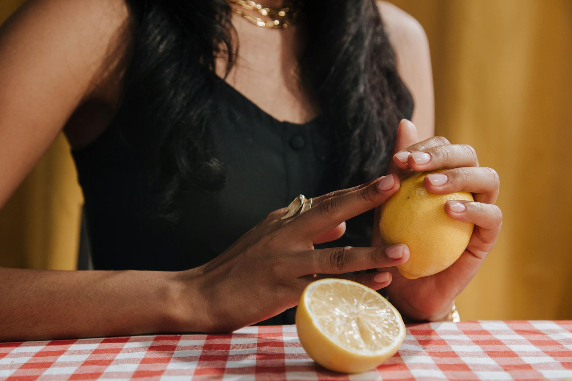 A yellow silicone clitoral vibrator surrounded by peeled bananas on a bright yellow background, symbolizing fresh postpartum recovery
